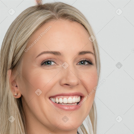 Joyful white young-adult female with long  brown hair and blue eyes