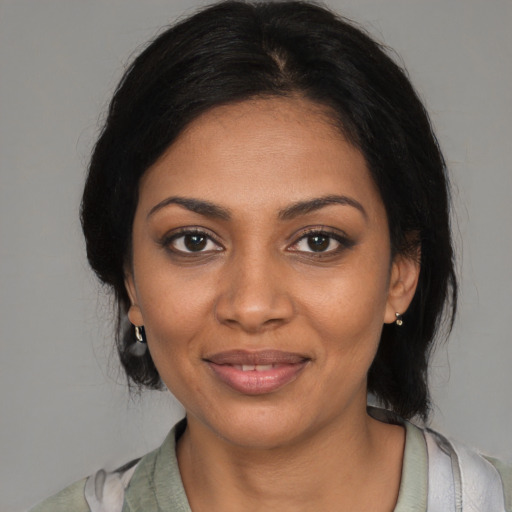 Joyful black young-adult female with medium  black hair and brown eyes