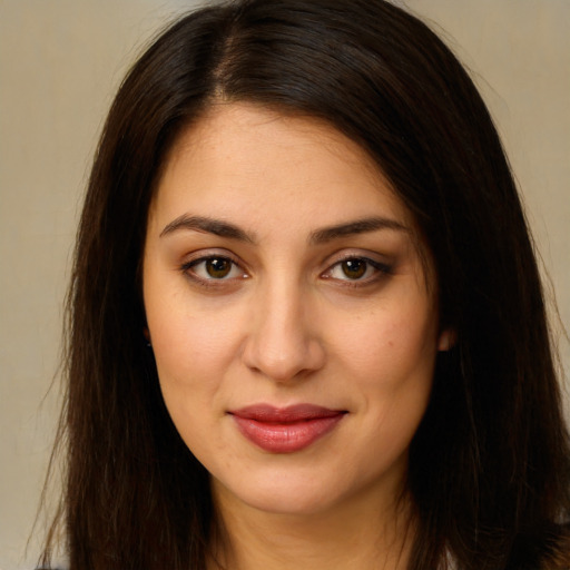 Joyful white young-adult female with long  brown hair and brown eyes