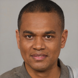 Joyful latino adult male with short  brown hair and brown eyes