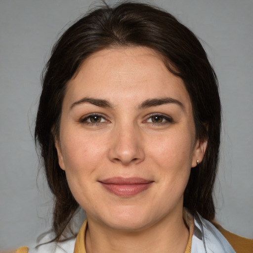 Joyful white adult female with medium  brown hair and brown eyes