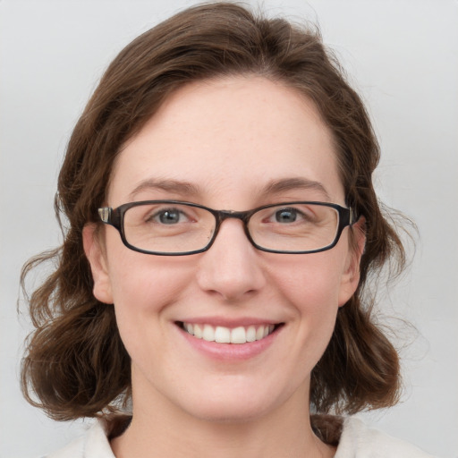 Joyful white young-adult female with medium  brown hair and blue eyes