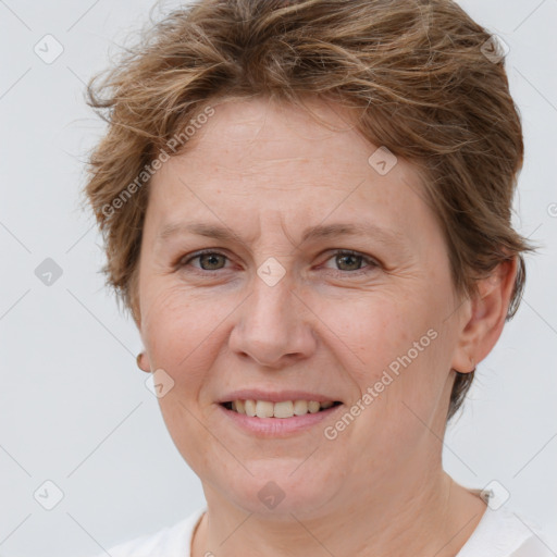 Joyful white adult female with short  brown hair and grey eyes