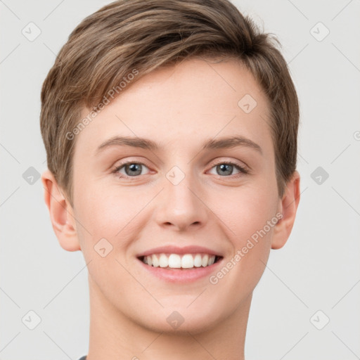 Joyful white young-adult female with short  brown hair and grey eyes