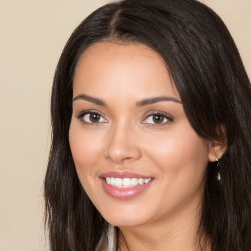 Joyful white young-adult female with long  black hair and brown eyes