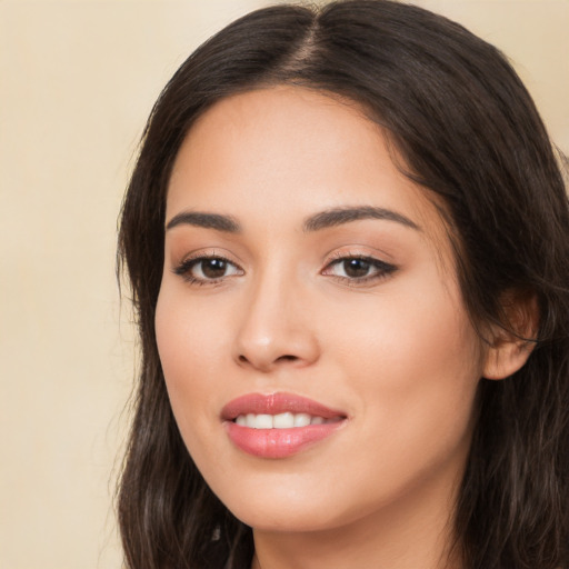 Joyful white young-adult female with long  brown hair and brown eyes