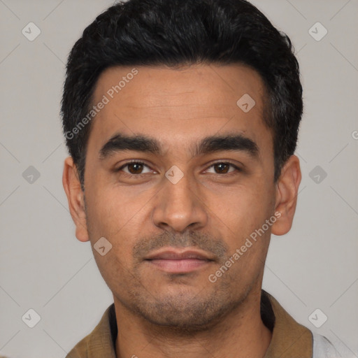 Joyful latino young-adult male with short  black hair and brown eyes