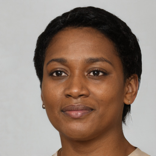 Joyful black adult female with short  black hair and brown eyes
