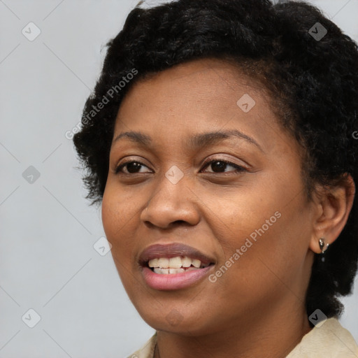 Joyful black young-adult female with short  black hair and brown eyes