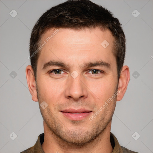 Joyful white young-adult male with short  brown hair and grey eyes