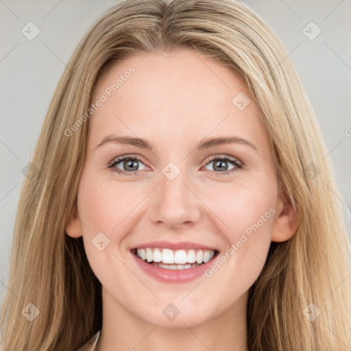 Joyful white young-adult female with long  brown hair and blue eyes