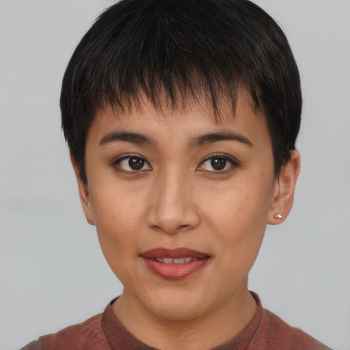 Joyful asian young-adult female with short  brown hair and brown eyes