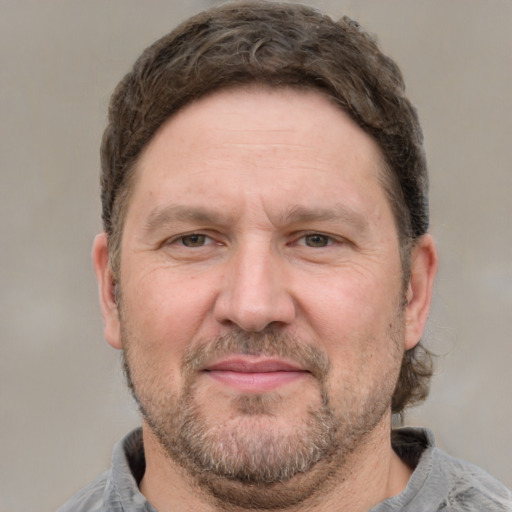 Joyful white adult male with short  brown hair and grey eyes