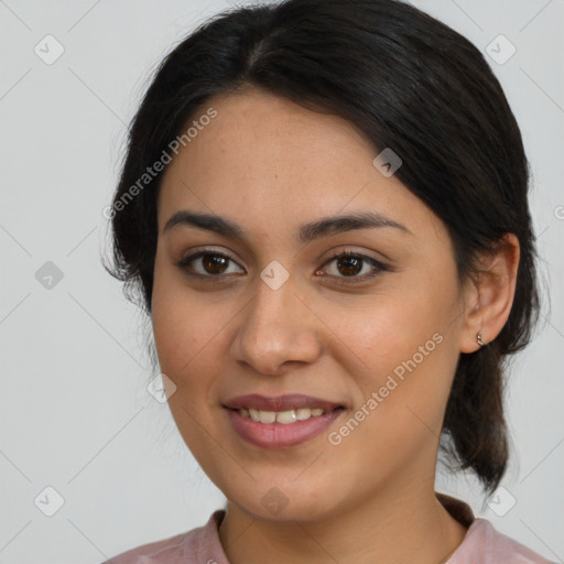 Joyful latino young-adult female with medium  brown hair and brown eyes