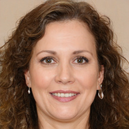 Joyful white adult female with long  brown hair and brown eyes