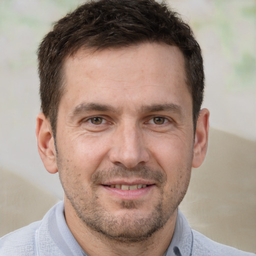 Joyful white adult male with short  brown hair and brown eyes