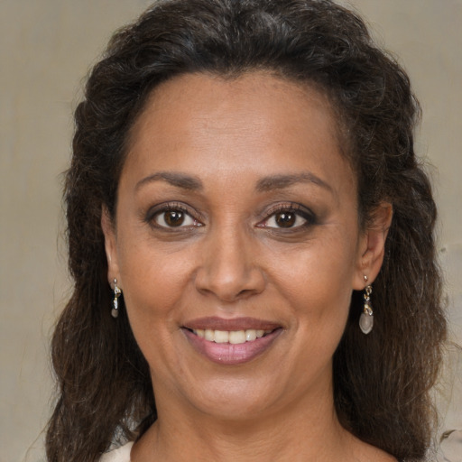 Joyful black adult female with medium  brown hair and brown eyes