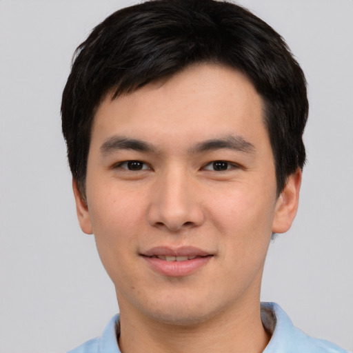 Joyful asian young-adult male with short  brown hair and brown eyes