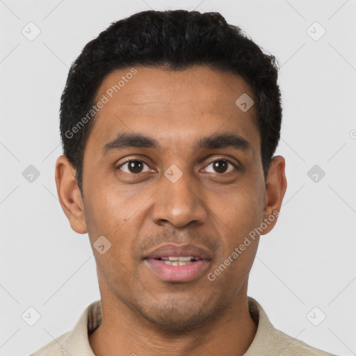 Joyful latino young-adult male with short  black hair and brown eyes