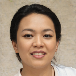 Joyful asian young-adult female with short  black hair and brown eyes