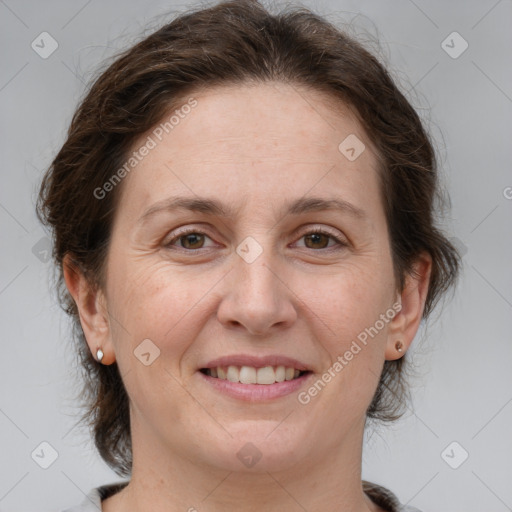 Joyful white adult female with medium  brown hair and grey eyes