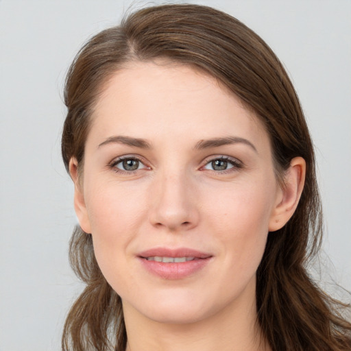 Joyful white young-adult female with long  brown hair and grey eyes