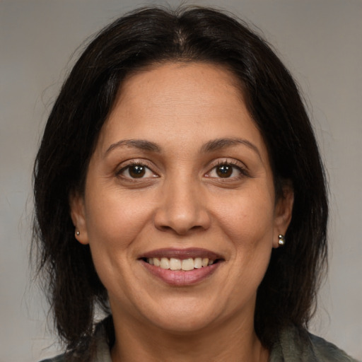 Joyful white adult female with medium  brown hair and brown eyes