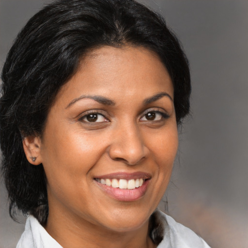 Joyful black young-adult female with medium  brown hair and brown eyes