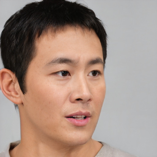 Neutral asian young-adult male with short  brown hair and brown eyes