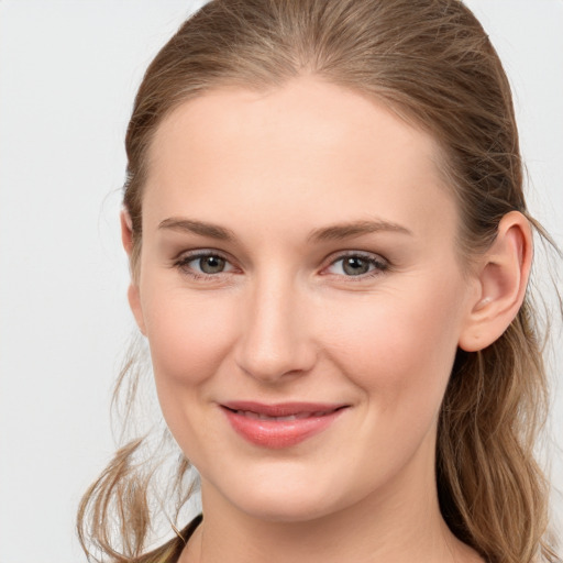 Joyful white young-adult female with long  brown hair and grey eyes