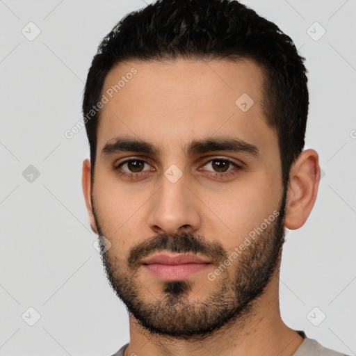 Neutral latino young-adult male with short  black hair and brown eyes