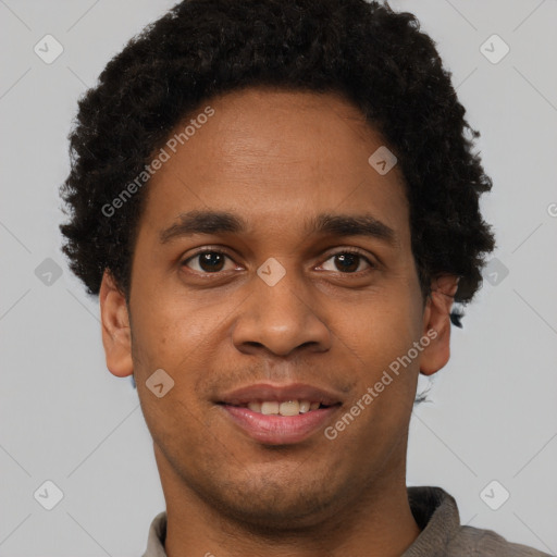 Joyful black young-adult male with short  brown hair and brown eyes