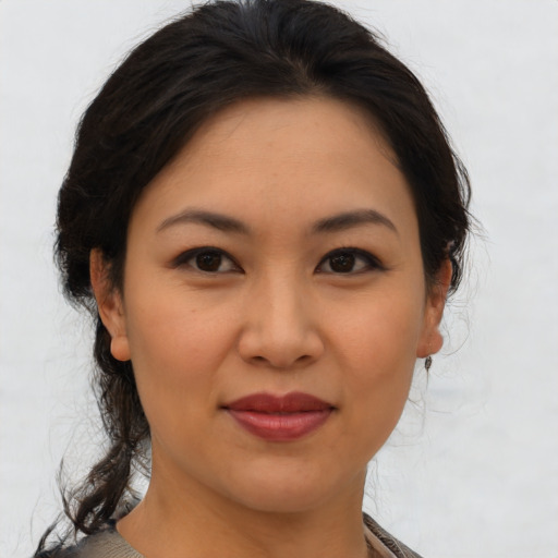 Joyful asian young-adult female with medium  brown hair and brown eyes