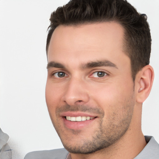 Joyful white young-adult male with short  brown hair and brown eyes