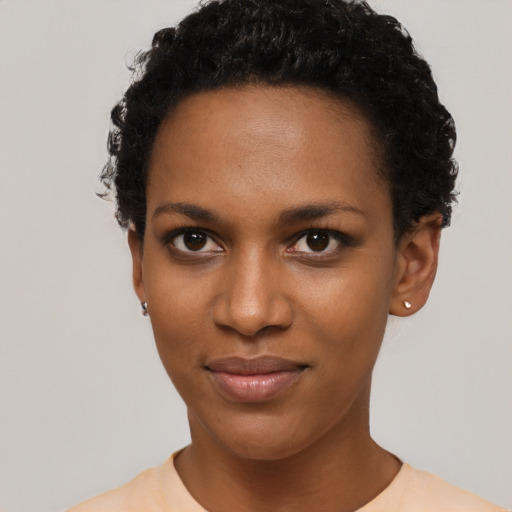 Joyful black young-adult female with short  brown hair and brown eyes