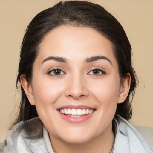 Joyful white young-adult female with medium  brown hair and brown eyes