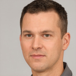 Joyful white adult male with short  brown hair and brown eyes