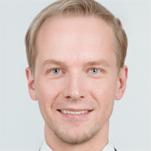 Joyful white adult male with short  brown hair and blue eyes