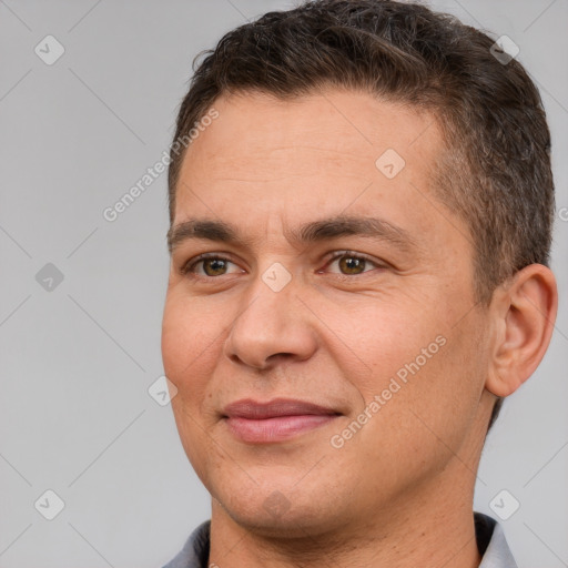 Joyful white adult male with short  brown hair and brown eyes