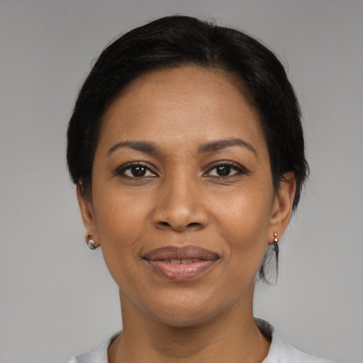 Joyful latino adult female with short  black hair and brown eyes