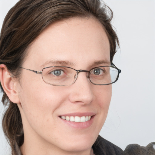 Joyful white young-adult female with medium  brown hair and blue eyes