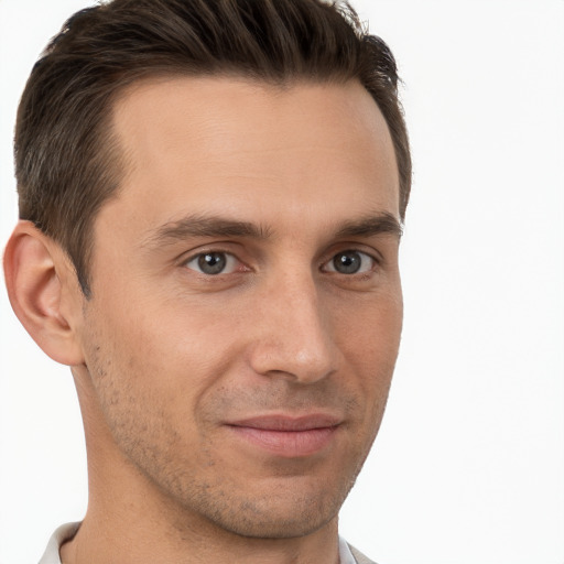 Joyful white young-adult male with short  brown hair and brown eyes