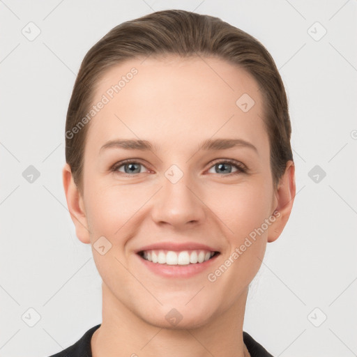 Joyful white young-adult female with short  brown hair and grey eyes