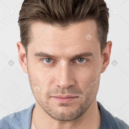 Joyful white young-adult male with short  brown hair and grey eyes