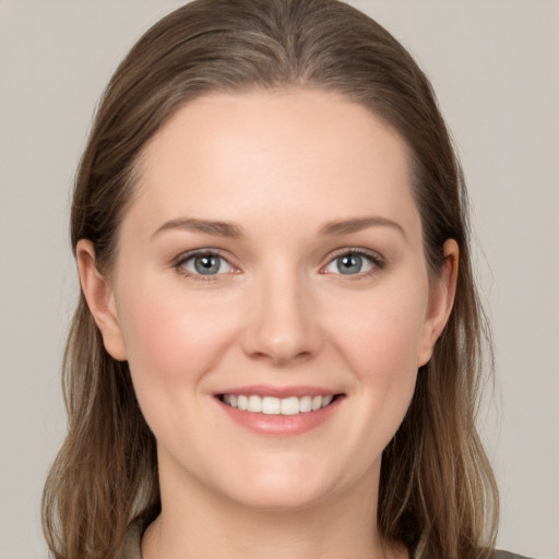 Joyful white young-adult female with long  brown hair and grey eyes