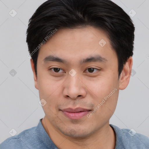 Joyful asian young-adult male with short  brown hair and brown eyes