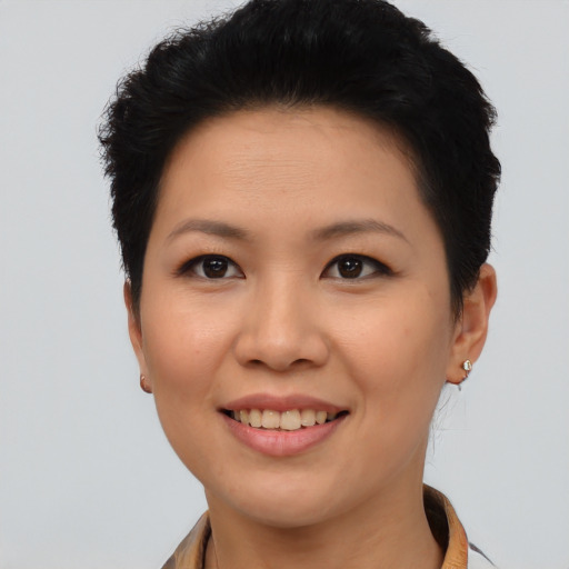 Joyful asian young-adult female with short  brown hair and brown eyes