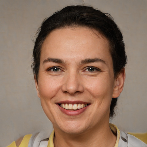 Joyful white adult female with short  brown hair and brown eyes