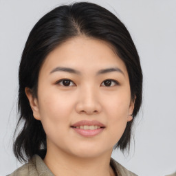 Joyful asian young-adult female with medium  black hair and brown eyes