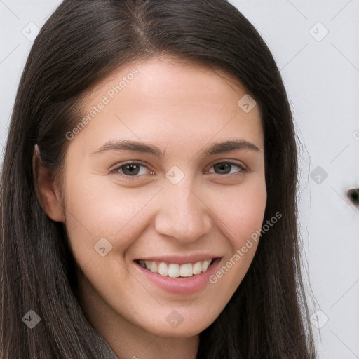 Joyful white young-adult female with long  brown hair and brown eyes